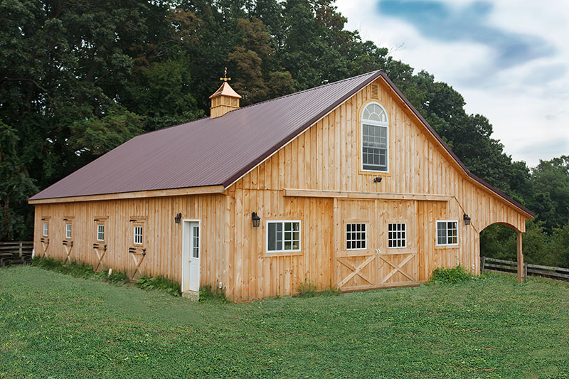 10x60 Horse Barn with Pole Barn Construction. Overhang with Arched Trim.