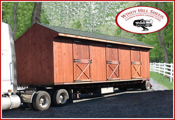 A shed from Windy Hill Sheds is delivered via semi-truck.