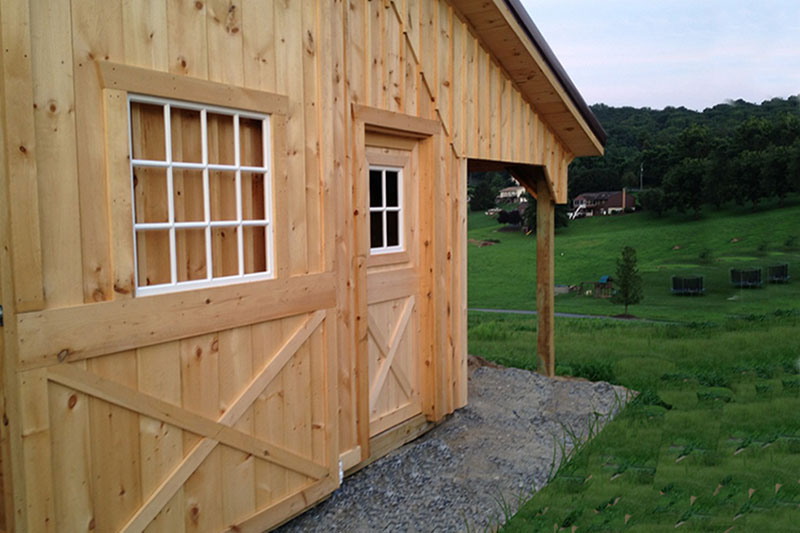 Modular Horse Barn Sliding Door to Aisle with 12-Lite Window. Entry Door to the Tack Room.