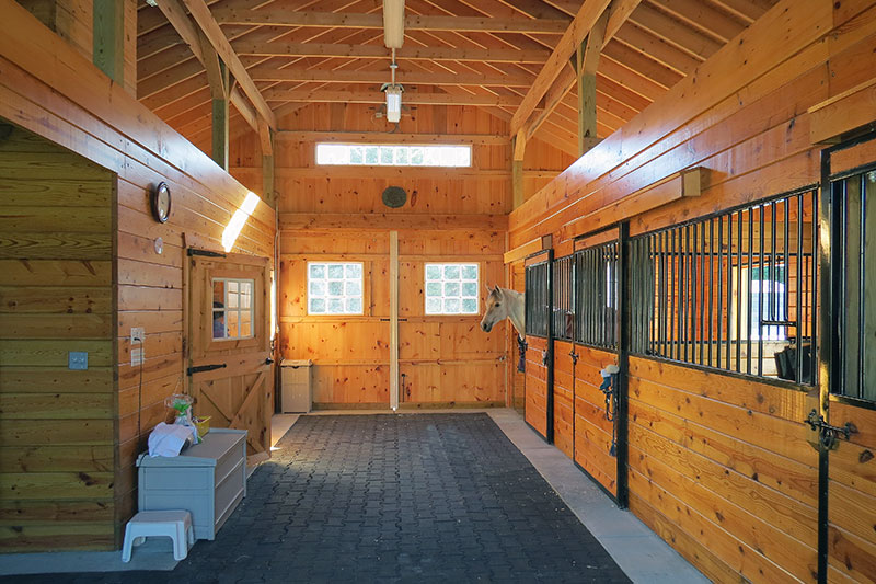 Inside this Modular Horse Barn.  Center aisle and stall fronts.